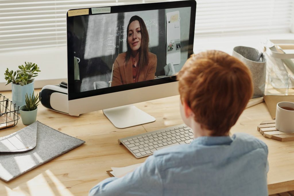 boy video calling his teacher