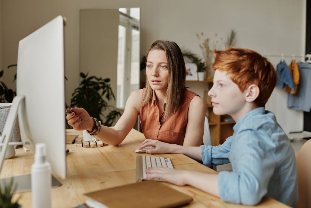 woman tutoring young boy